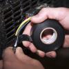 imageDuck Brand Professional Electrical Tape 075Inch by 66Feet Single Roll with Dispenser Black 299023